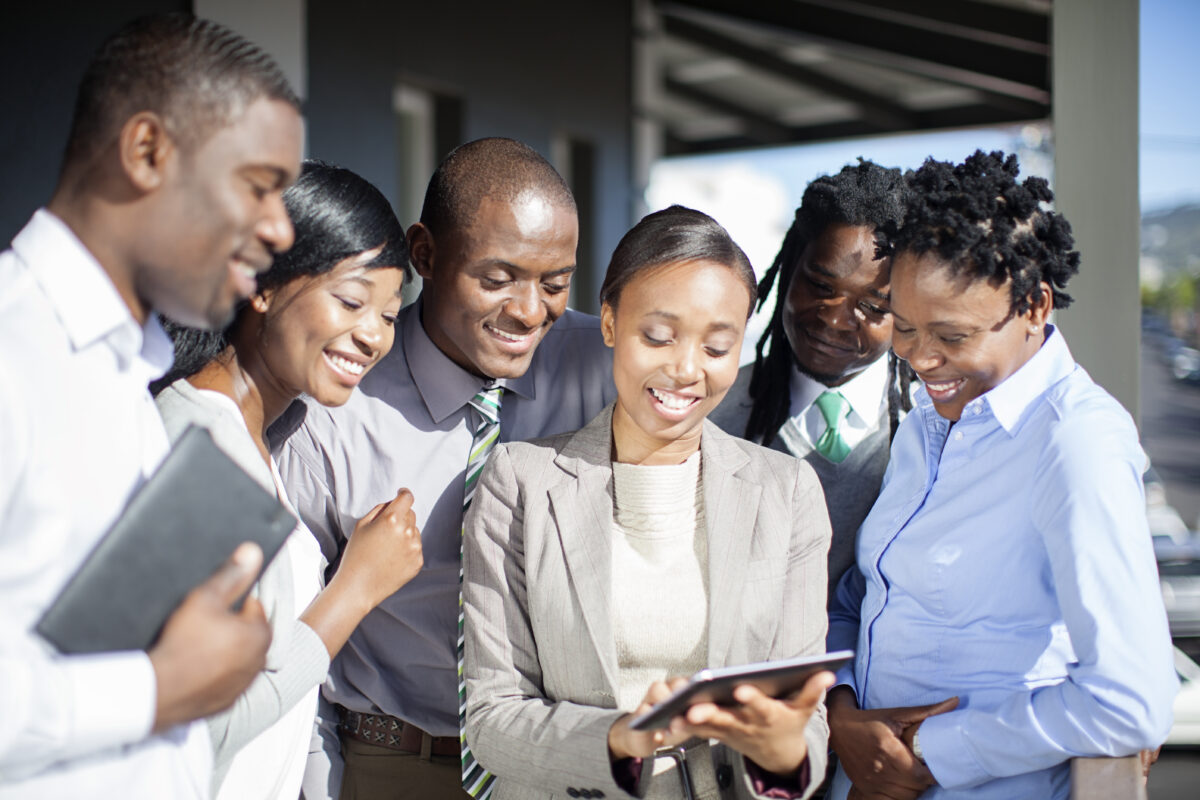 Group of professionals smiling and looking at a document together